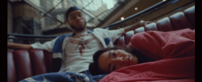 a man and a woman laying on a bed