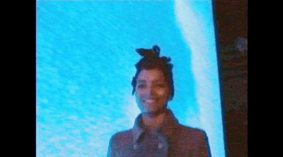 a man standing in front of a blue screen