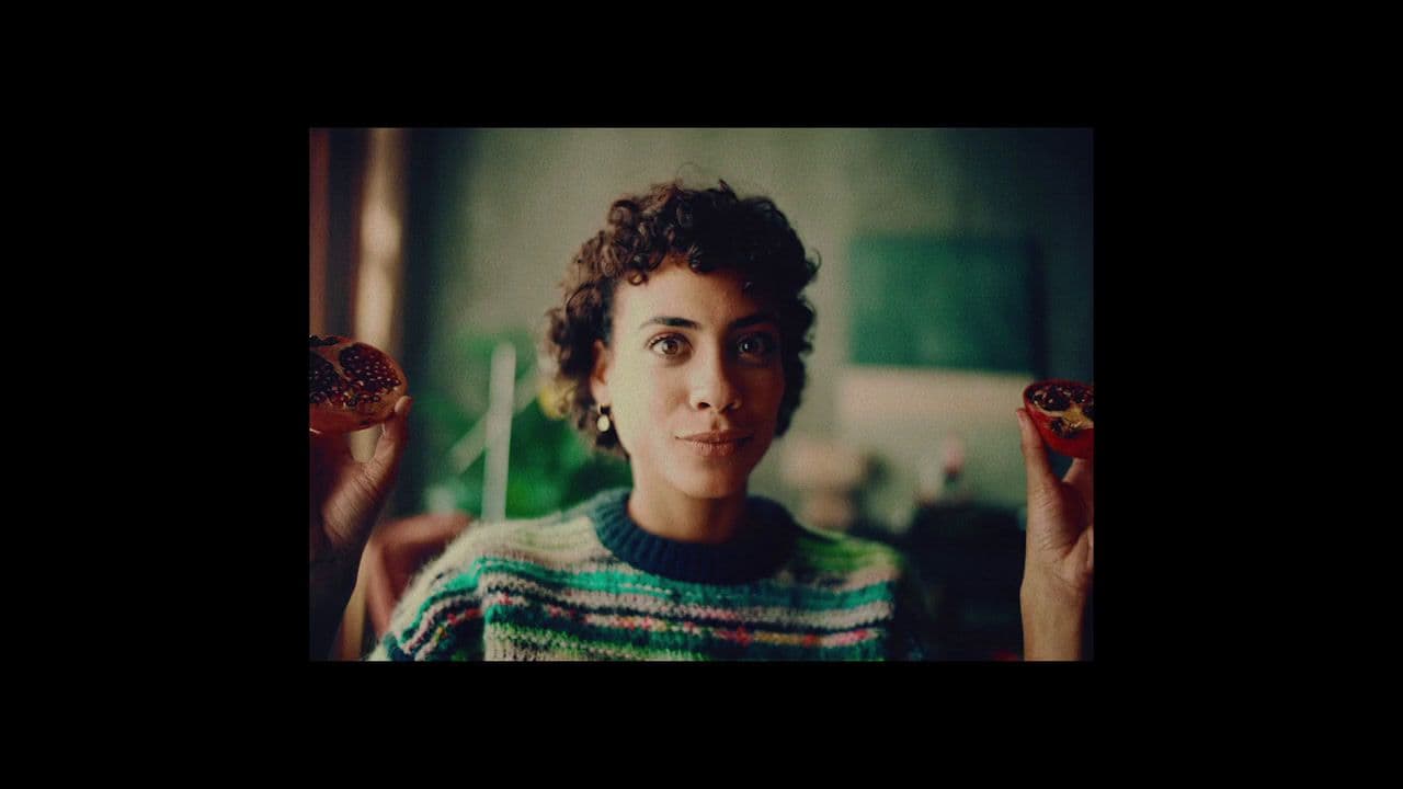 a woman holding two donuts in her hands