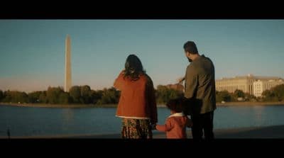 a group of people standing next to a body of water