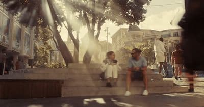 a group of people sitting on the steps of a building