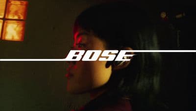 a woman standing in front of a window with the word boss on it
