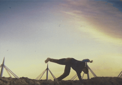 a man in a suit is walking on a hill