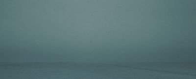 an airplane flying in the sky on a foggy day