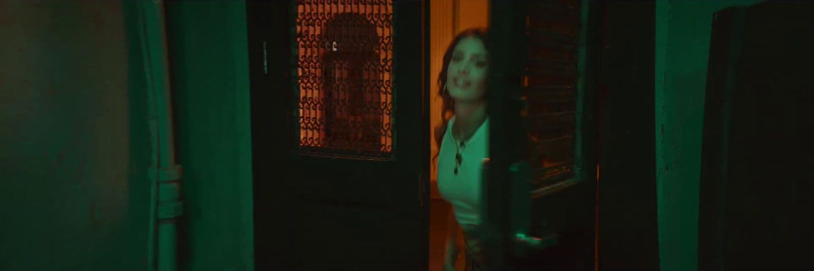 a woman standing in front of a green door