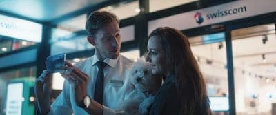 a man and a woman looking at a cell phone