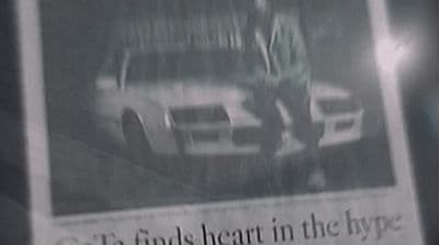 a newspaper with a picture of a man standing next to a car