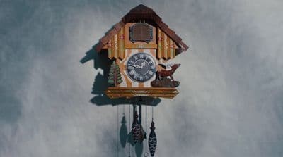 a clock with a deer on the front of it