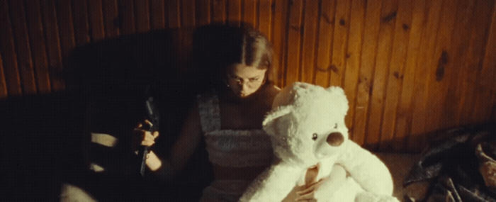 a woman holding a large white teddy bear