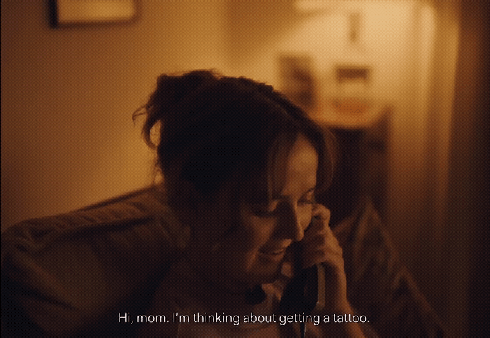 a woman talking on a cell phone in a dimly lit room