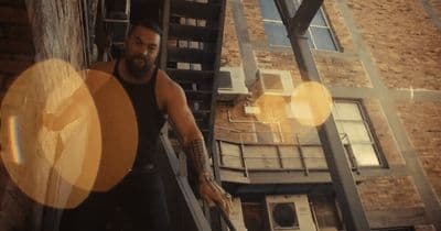 a man with a beard is climbing a set of stairs