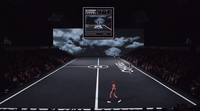 a woman walking across a tennis court in front of a crowd