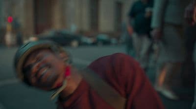 a man in a red shirt is smiling