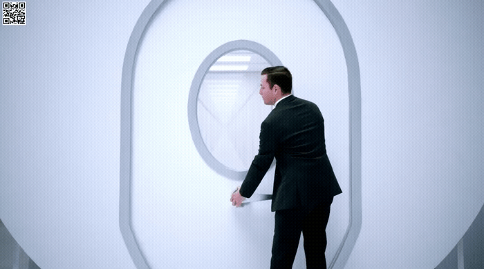 a man in a suit looking out of a window