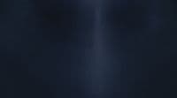 a black wall with a white light shining on it