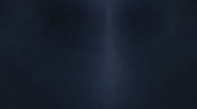 a black wall with a white light shining on it
