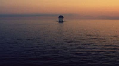 a large boat floating on top of a large body of water