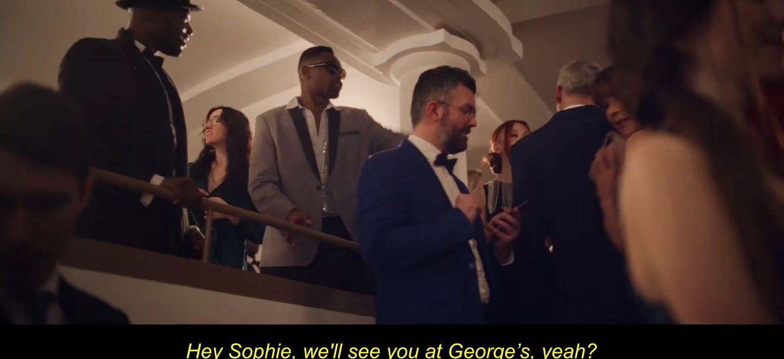 a group of people standing around each other