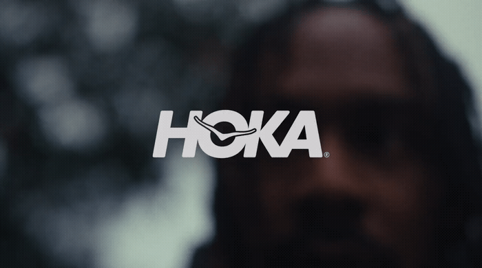 a close up of a person's face with the word hoka on it