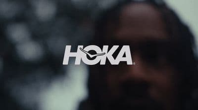a close up of a person's face with the word hoka on it