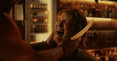 a man holding a knife in front of his face