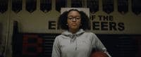 a woman holding a basketball in a gym
