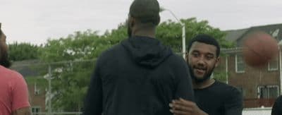 a group of young men playing a game of basketball
