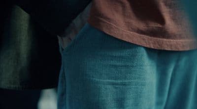 a close up of a person wearing blue pants