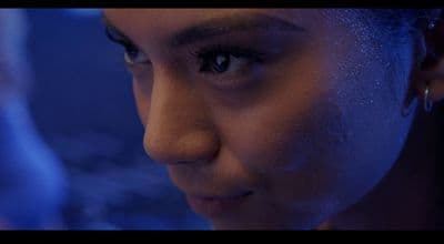 a close up of a woman's face in the dark