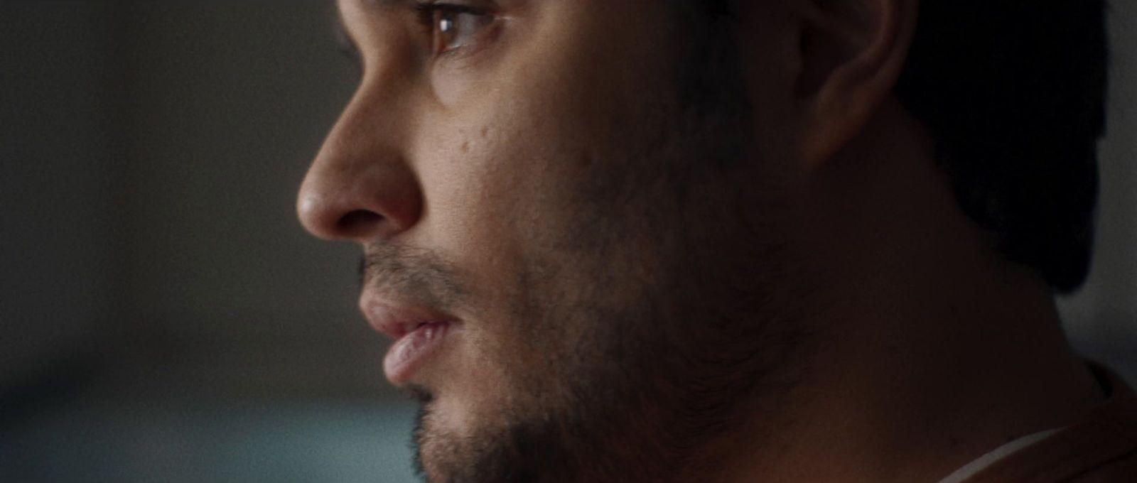 a close up of a man's face in the dark