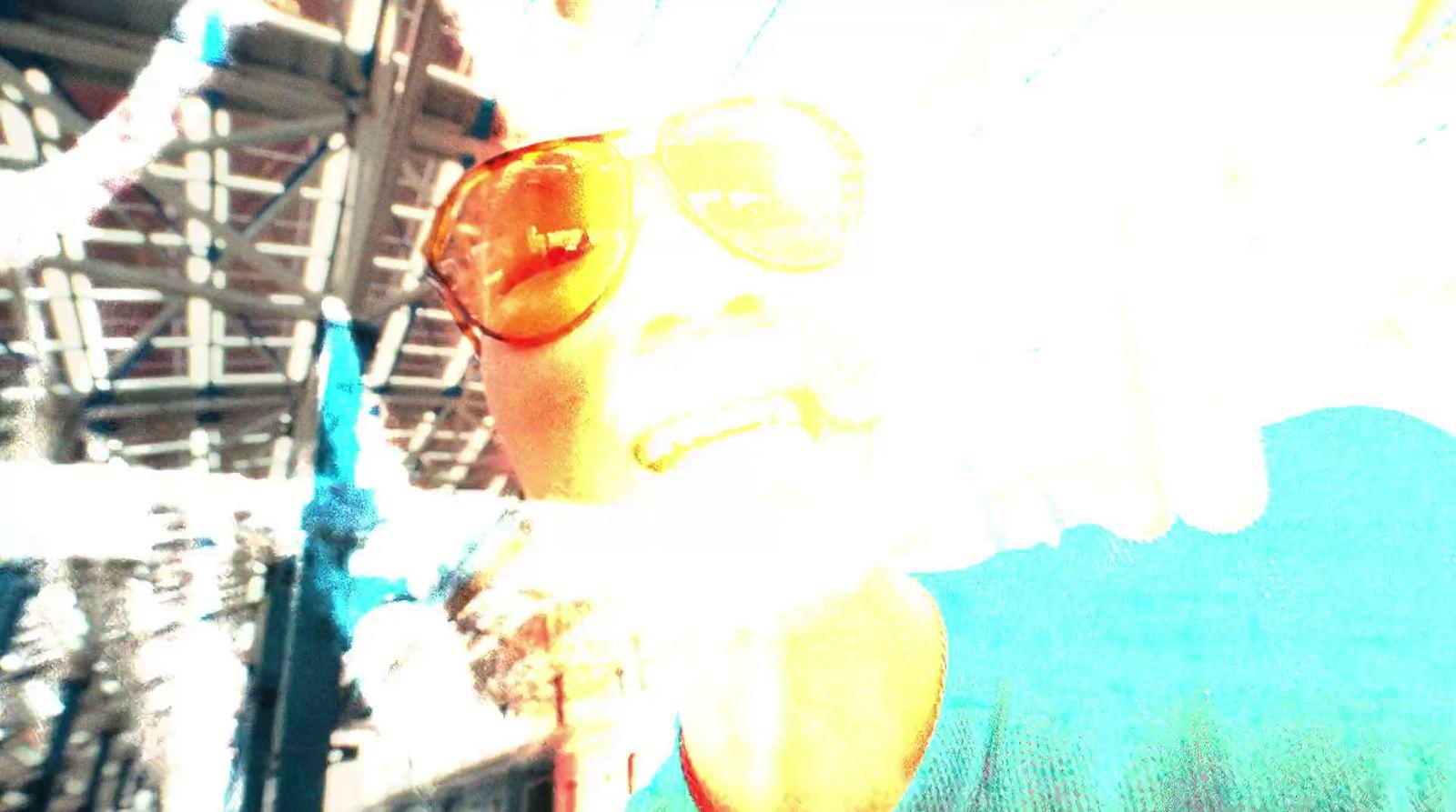 a woman wearing sun glasses and a blue shirt