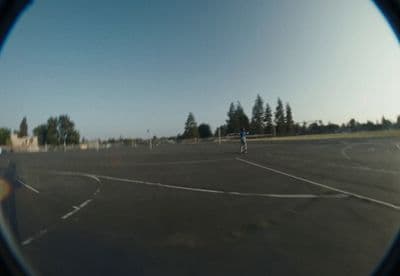 a person standing in a parking lot with a frisbee