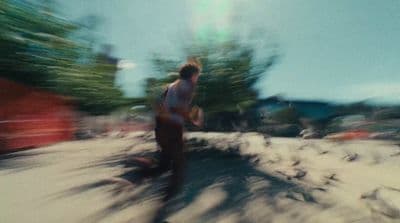 a blurry photo of a man walking down a street