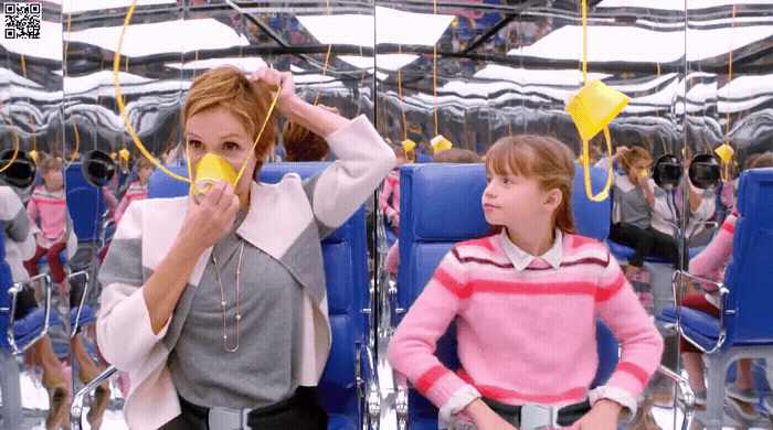 a woman sitting next to a little girl on a blue chair