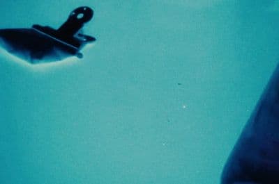 a close up of a person's hand holding a toothbrush