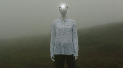 a mannequin is standing in a foggy field