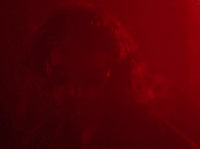 a man in a red room with a red light