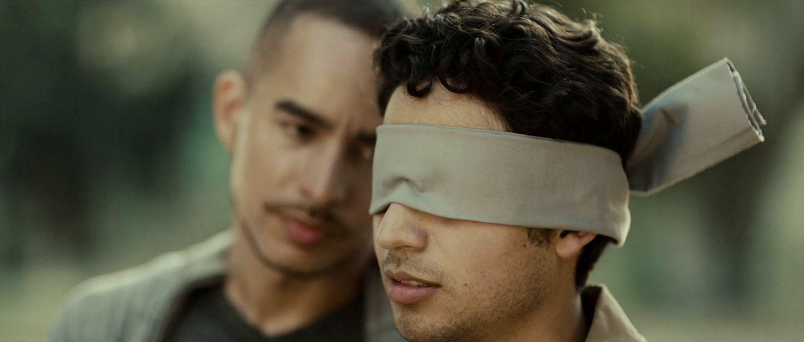 a couple of men with blindfolds on their eyes