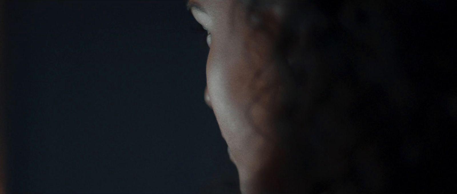 a blurry image of a woman's face in the dark