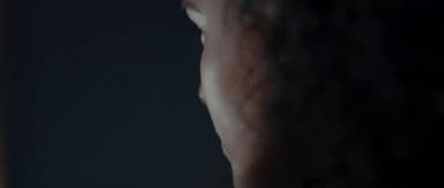 a blurry image of a woman's face in the dark