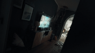 a dark room with a television on a stand