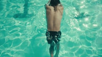 a man swimming in a pool of water