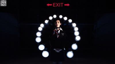 a man standing in front of a circular light