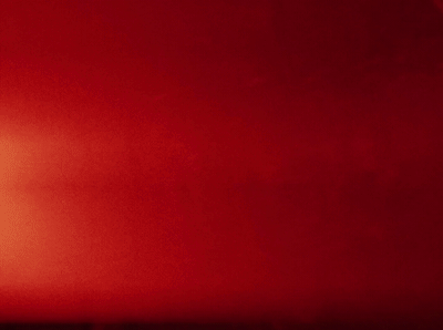a red wall with a clock on it