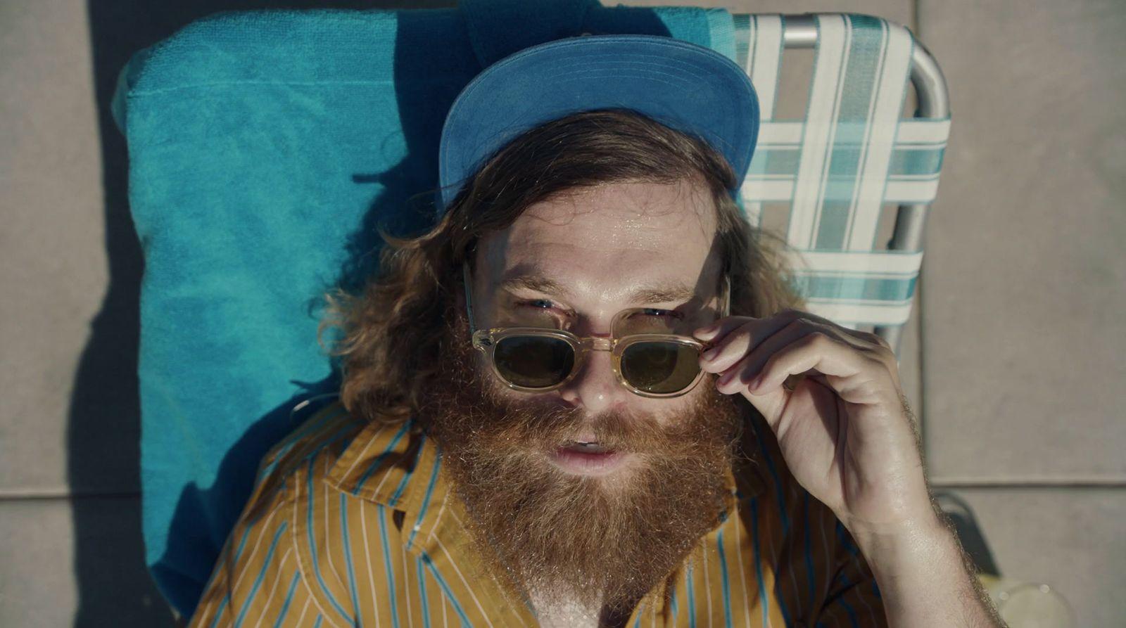 a man with a beard wearing sunglasses and a hat