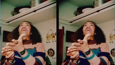 a woman is making a funny face while holding a toothbrush