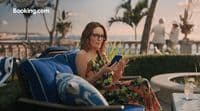 a woman sitting in a chair looking at a tablet