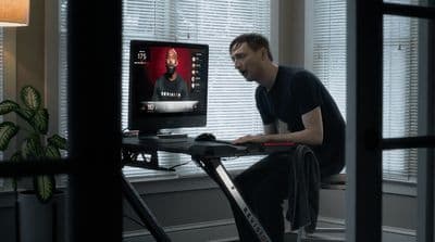 a man sitting at a desk using a computer