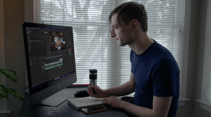 a man sitting in front of a computer monitor