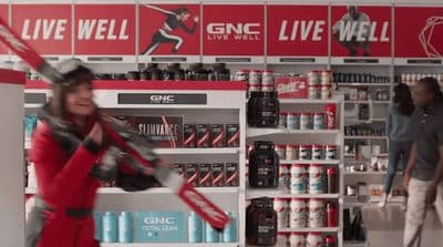 a woman holding a baseball bat in a store